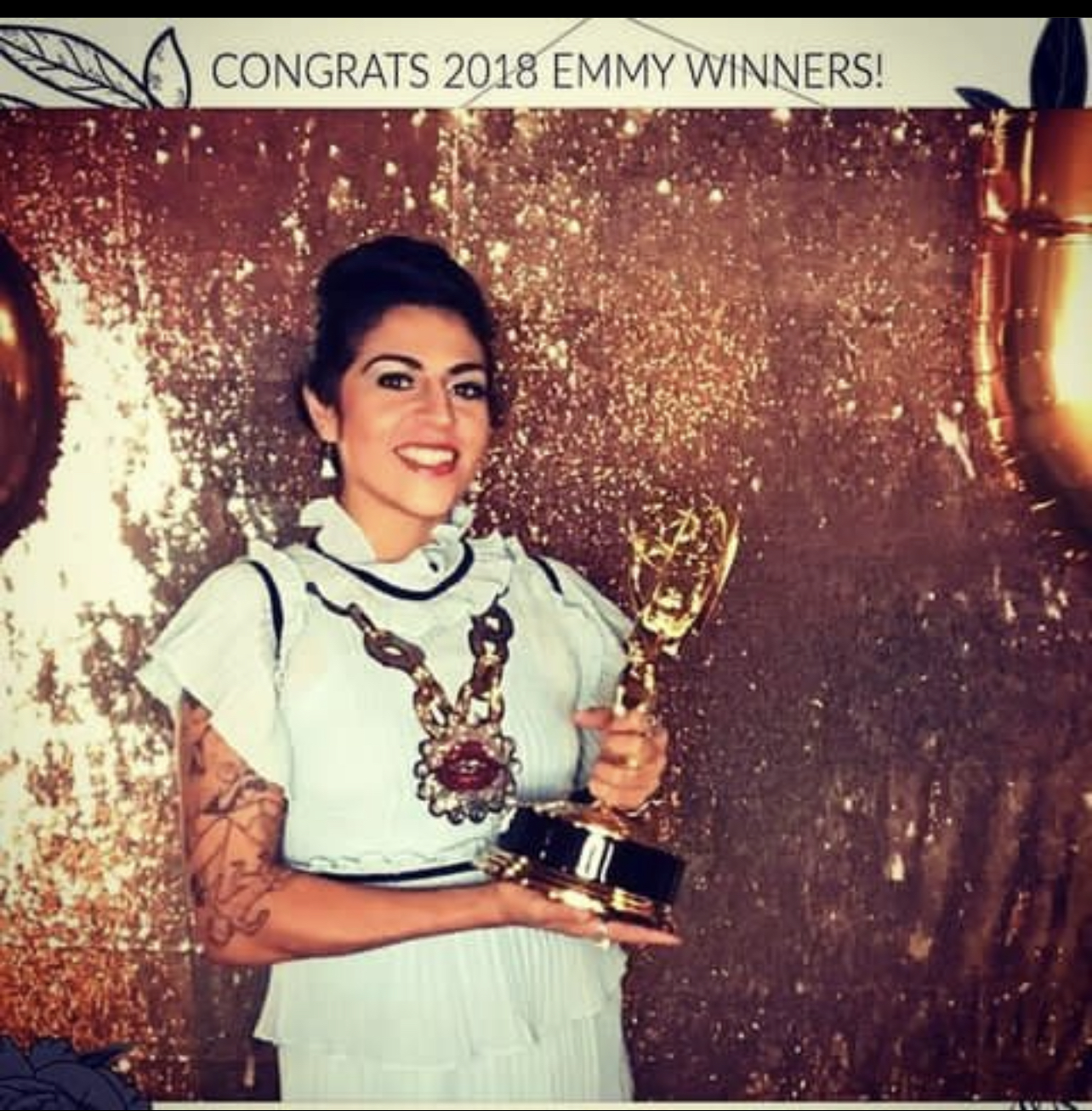 Niña Terca holding her Emmy Award, 2018